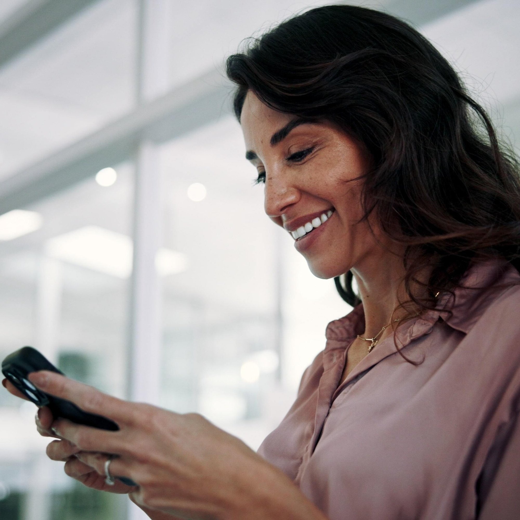 woman and smile with phone in office for communication_1077981454-min-1-1-1